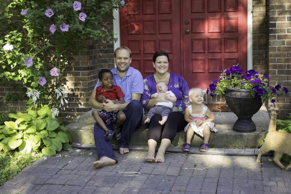 Jane Seib family photo, husband and three children sitting on the doorstep