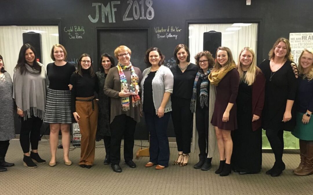 group of 14 board members smiling for picture