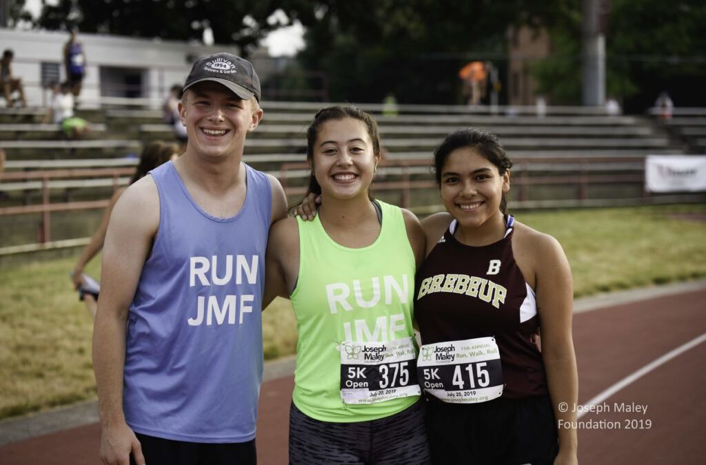 Three Run, Walk, Roll participants posting together and smiling.