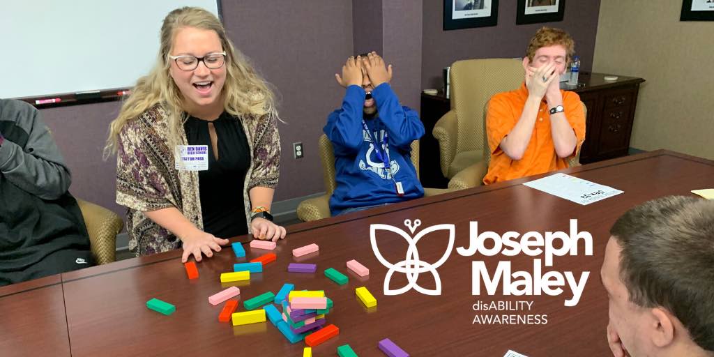 Two kids laughing with their teacher while they play with colorful blocks at a table with Joseph Maley Foundation Graphic